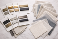 Drapery hardware finish samples and fabric swatches displayed for selecting window treatment materials and finishes.